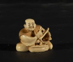 Japanese Netsuke on Mammoth Tusk (Mammuthus primigenius) depicting peddler, 19th century Japanese sc