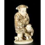 Japanese Netsuke on Mammoth Tusk (Mammuthus primigenius) representing old man with child, 19th centu