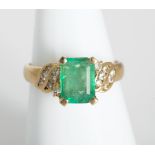 18kt gold emerald and diamond ring.