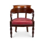 An early 19th century French Empire mahogany fauteuil de bureau or desk chair