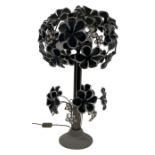 A 1970's gun metal and glass tree two-light lamp with flowerhead decoration