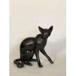 A patinated bronze figure of a seated Siamese cat