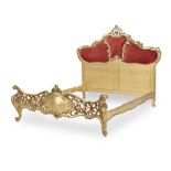 A 19th century and later rococo style carved giltwood bed