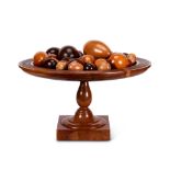 A large yew wood tazza or stand with a collection forty eight wooden specimen eggs