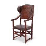 An 18th century North Italian carved walnut wing open armchair