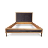 A contemporary limed oak kingsize bed frame with a padded headboard by Graham and Green