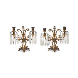 A pair of Regency gilt and patinated bronze cut glass twin light candelabra