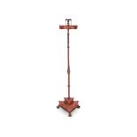 An early 19th century red painted iron and tôleware candlestand