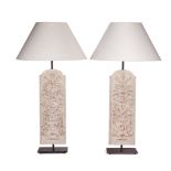 A pair of carved wooden and ebonised metal table lamps