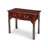 A George III mahogany serpentine writing table