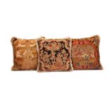 A group of three needlework cushions