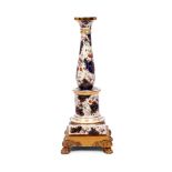 A 19th century French porcelain column on a gilt bronze base