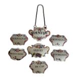 A group of seven late 18th century South Staffordshire enamel decanter labels or bottle tickets