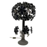 A 1970's gun metal and plastic tree two-light lamp with flowerhead decoration