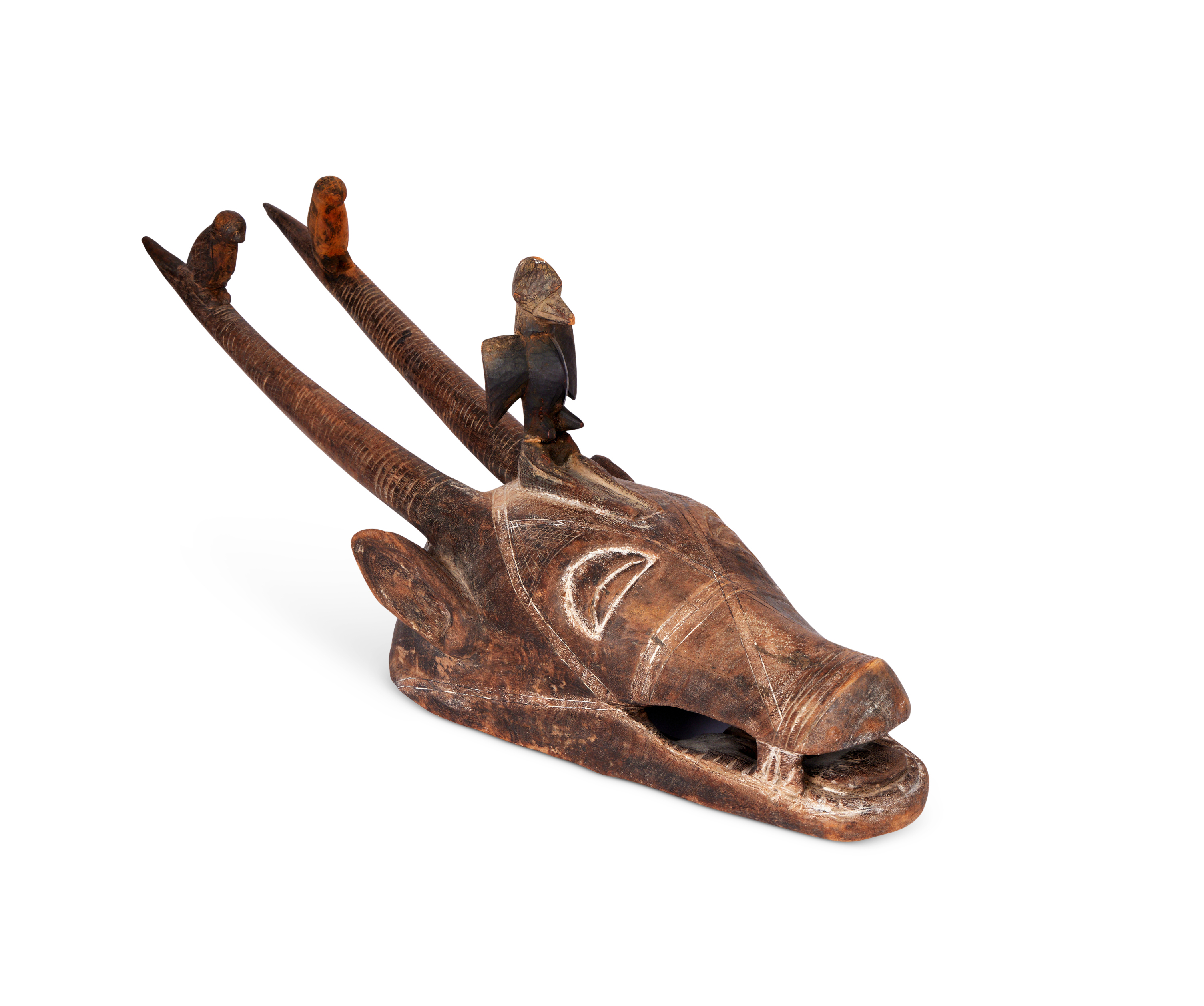 A West African Ivory Coast carved wooden Guro mask in the form of an antelope with birds