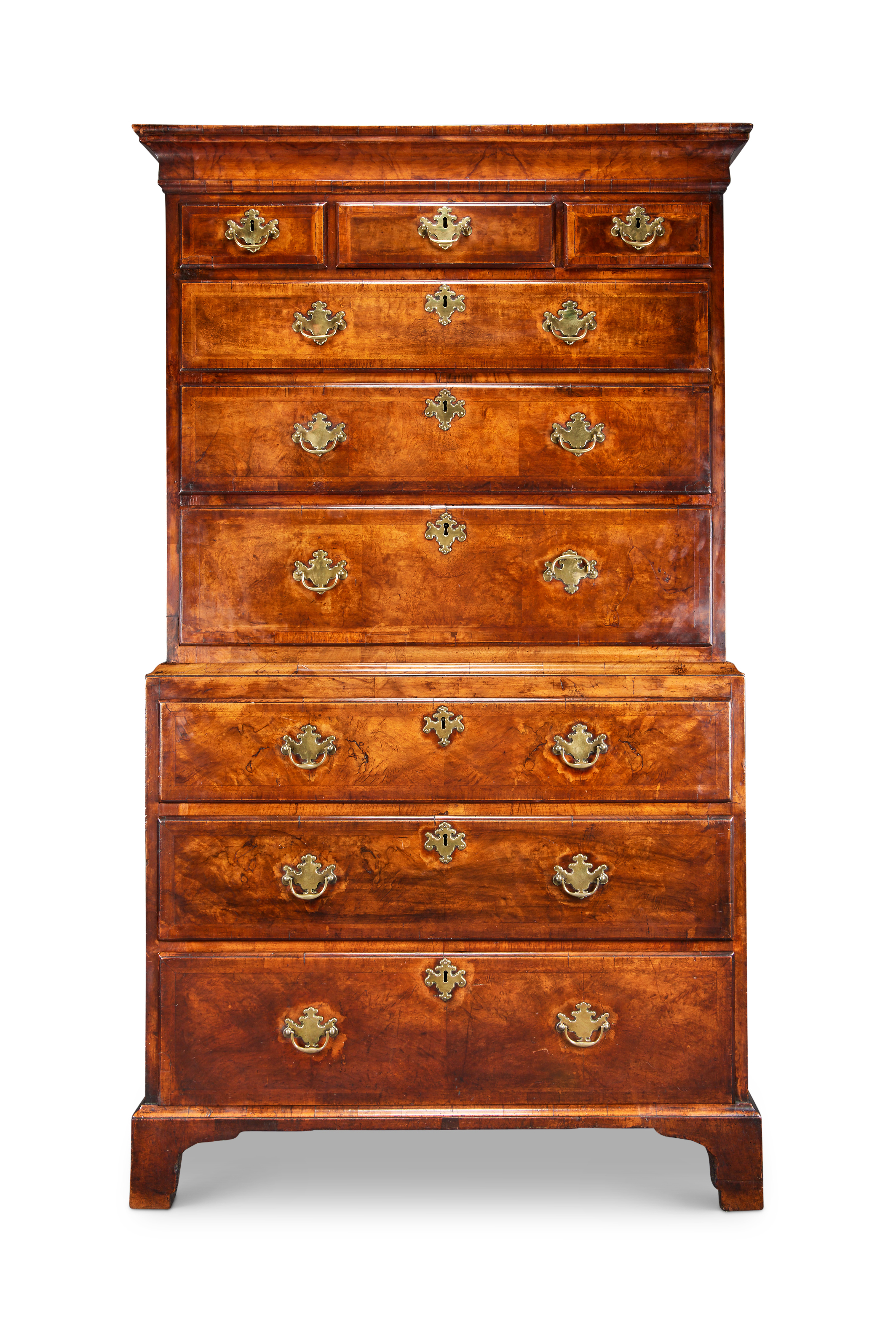 A George I walnut feather banded and crossbanded chest on chest