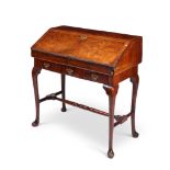 A walnut crossbanded and featherbanded bureau