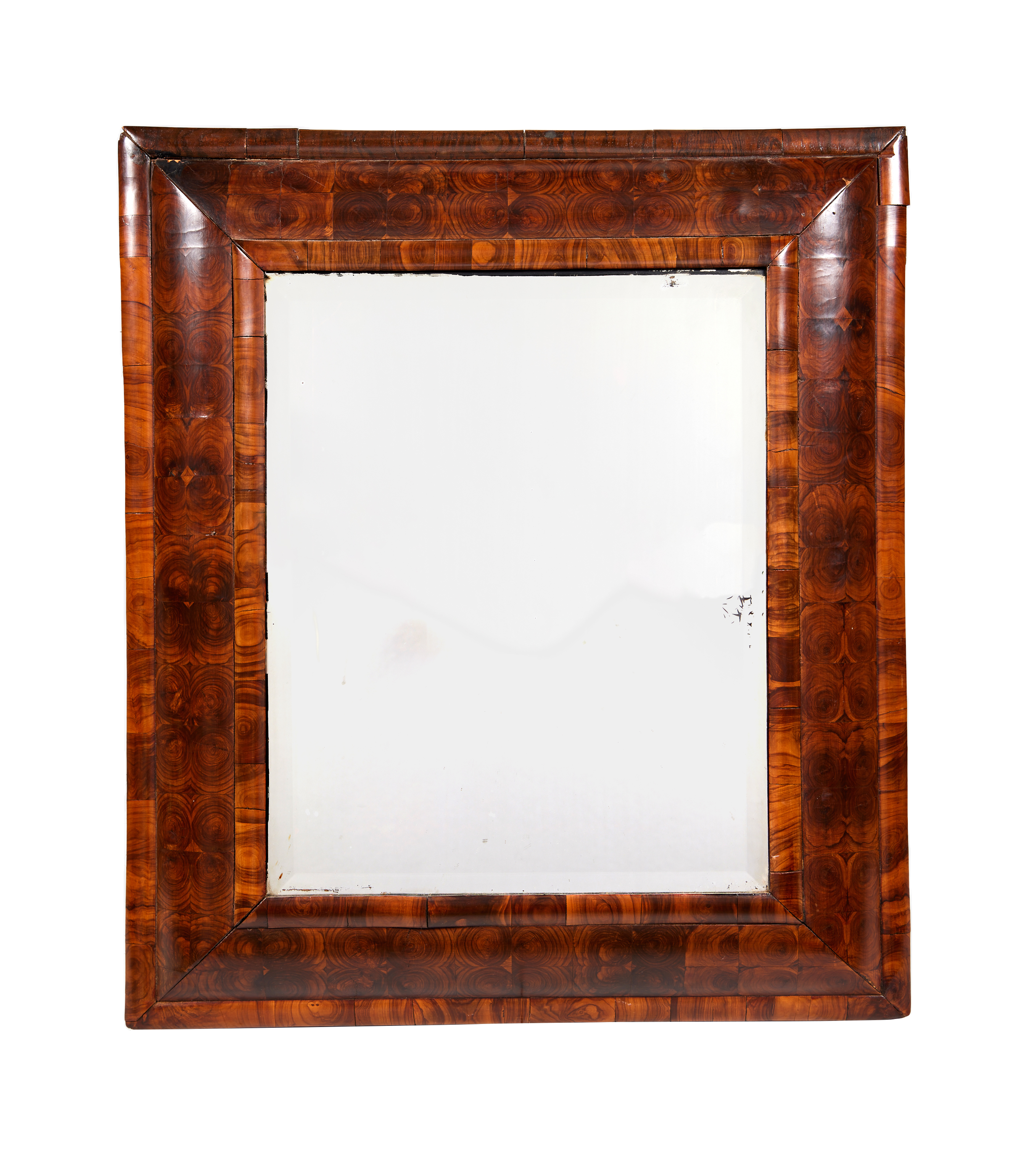 A William & Mary walnut oyster veneered cushion framed mirror