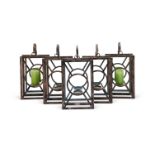 A set of five antiqued metal hanging mirror backed candle holders