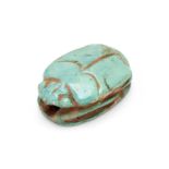 An Ancient Egyptian green glazed faience amulet bead in the form of scarab beetle