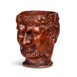 A 19th century terracotta libation cup in the form of the head of Bacchus