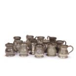 A mixed group of fourteen 18th and 19th century pewter baluster half pint handled tankards
