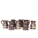 Eight 18th century pewter baluster pint tankards