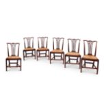 A set of six George III oak rush seat dining chairs