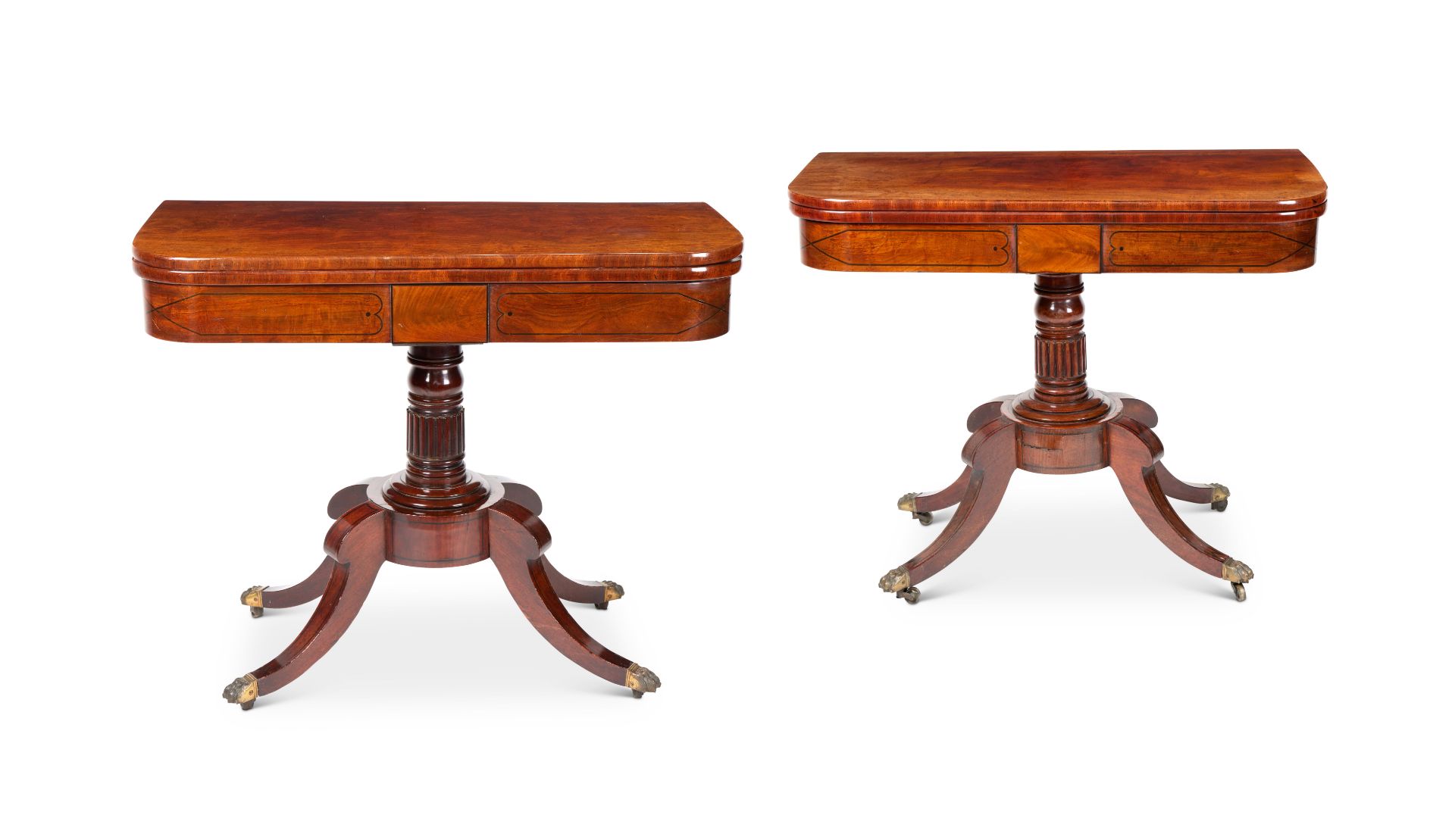 A pair of Regency mahogany and ebony line and dot inlaid card tables