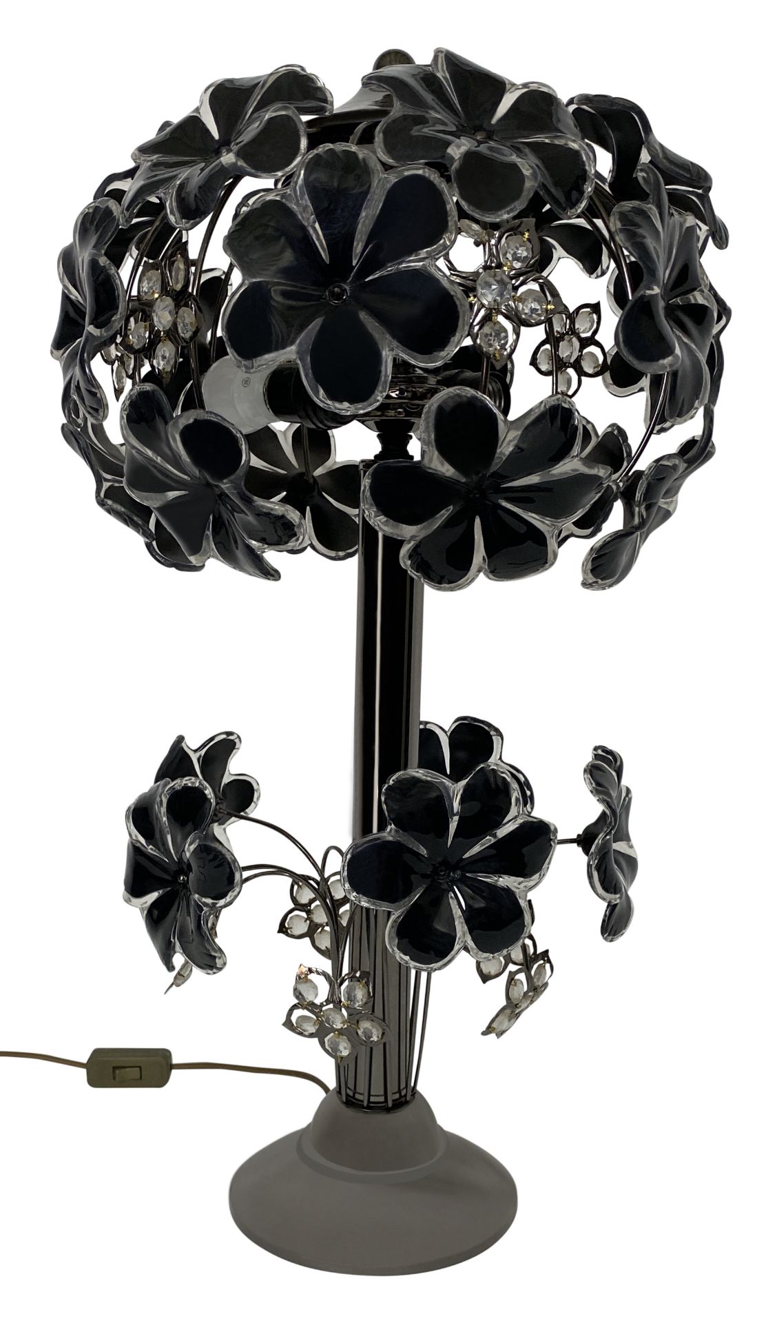 A gun metal and plastic tree two-light lamp with flowerhead decoration