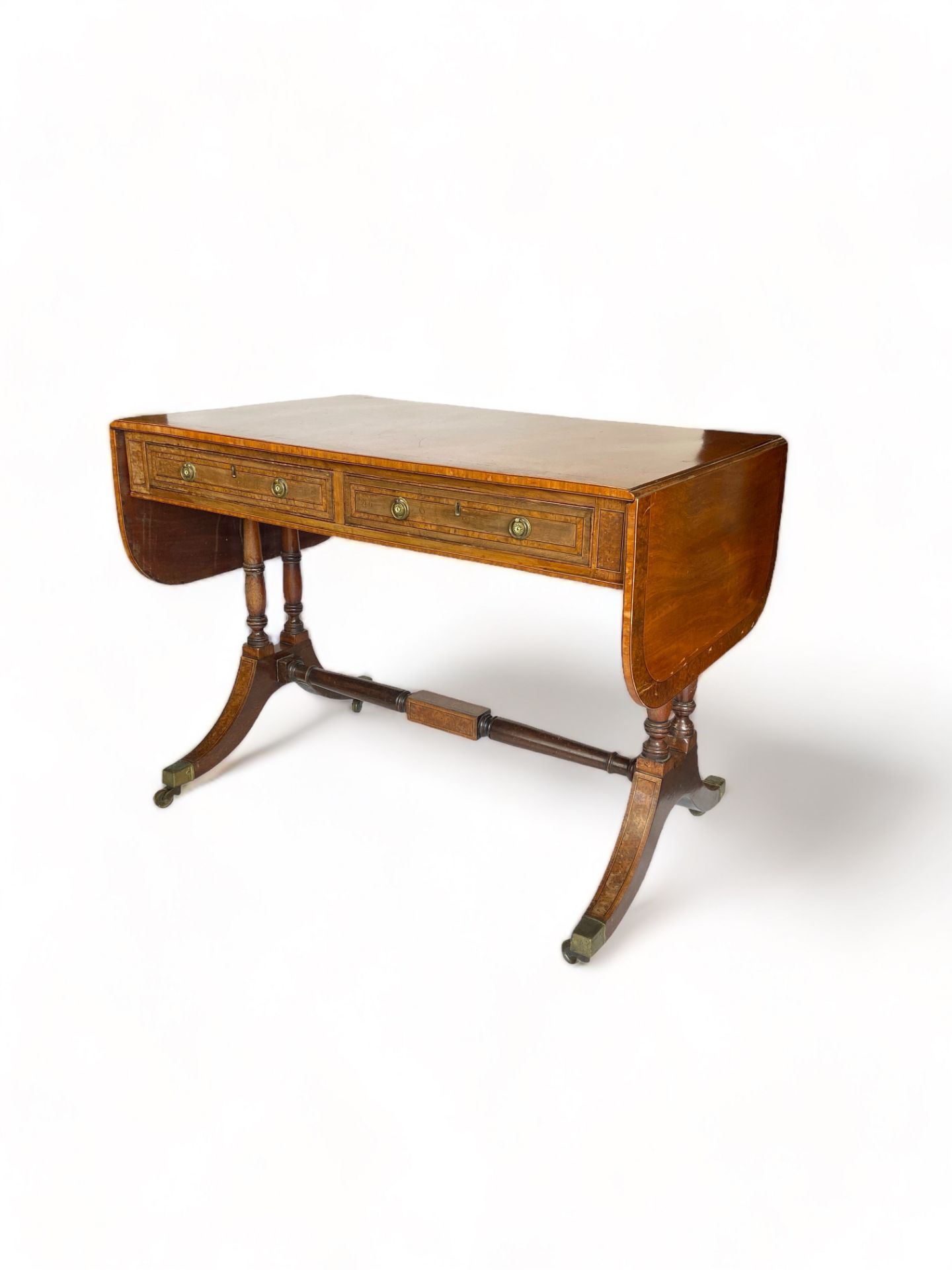 A Regency style mahogany and yew wood banded sofa table