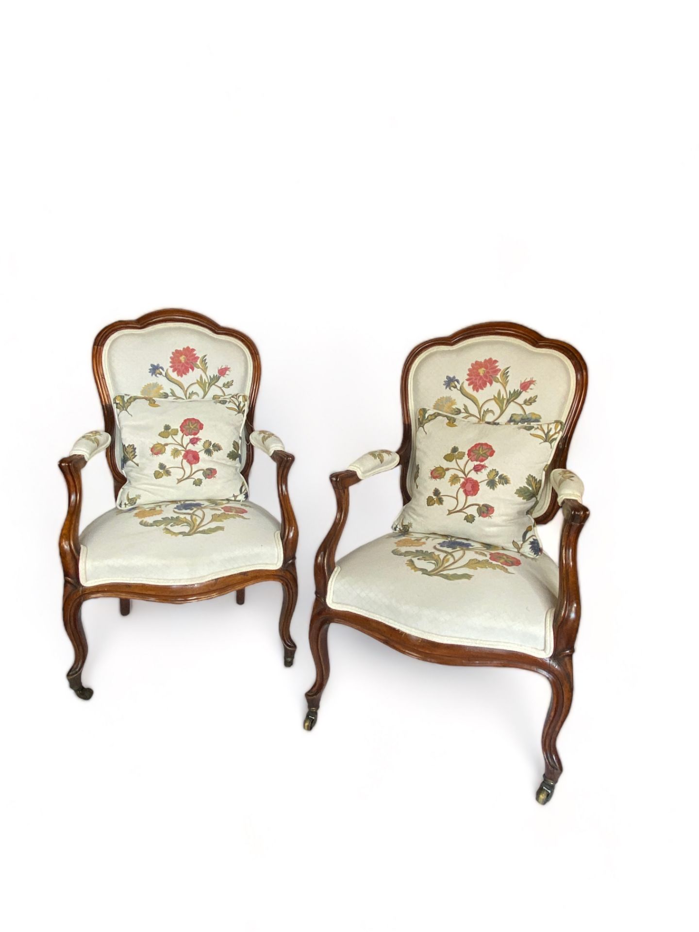 A pair of 19th century French Louis XV style mahogany cream floral upholstered fauteuils