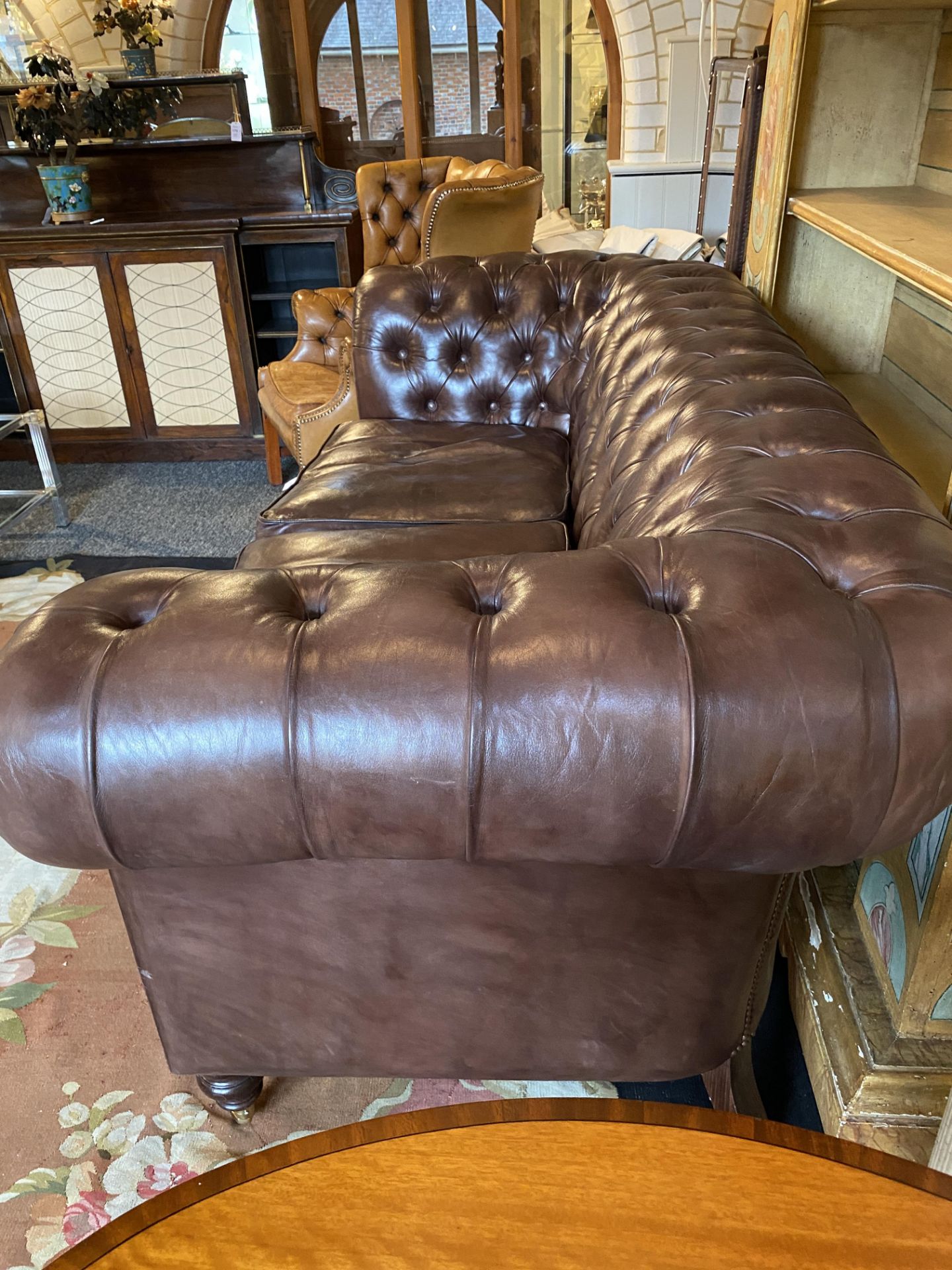 A contemporary brown leather and close-nailed two-seater Chesterfield sofa by The Original Sofa Co. - Image 2 of 5
