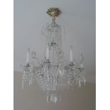 A contemporary silvered metal and cut glass eight light chandelier