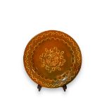 A vintage slipware decorated charger