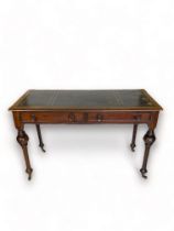 A Victorian mahogany writing table The rectangular moulded top with blue and gilt tooled leather