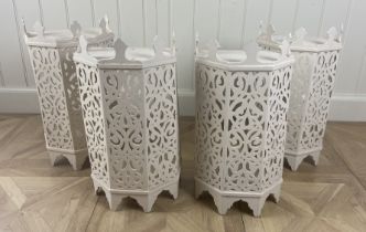 A set of four white painted pierced Moorish style light covers With facetted sides on bracket