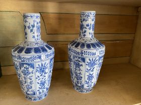 A pair of modern Chinese blue and white vases With long necks and ovoid bodies on turned bases, each
