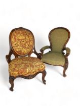 Two Victorian carved walnut salon armchairs