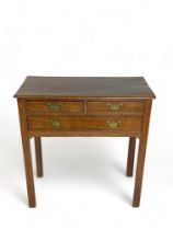 A George III mahogany lowboy  The rectangular moulded top above two short and one long drawer on