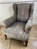A late Victorian Howard style upholstered armchair The rectangular padded back, shaped sides and