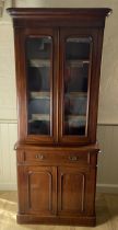 A Victorian mahogany bookcase cabinet The rounded moulded cornice above a pair of glazed doors