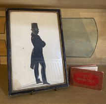 A 19th century framed silhouette of a gentleman and a small souvenir book of '12 Views of the