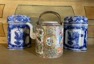 A late 19th century Cantonese tea pot and a pair of blue and white jars and covers  The tea pot,