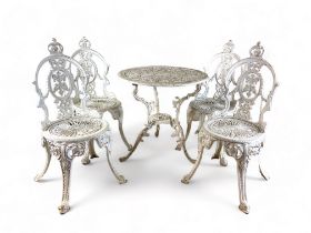 A vintage Victorian style white painted and pierced metal suite of garden dining furniture