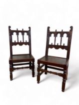 A matched pair of 17th century style Derbyshire carved oak chairs