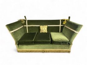 A vintage Knowle sofa upholstered in green velvet