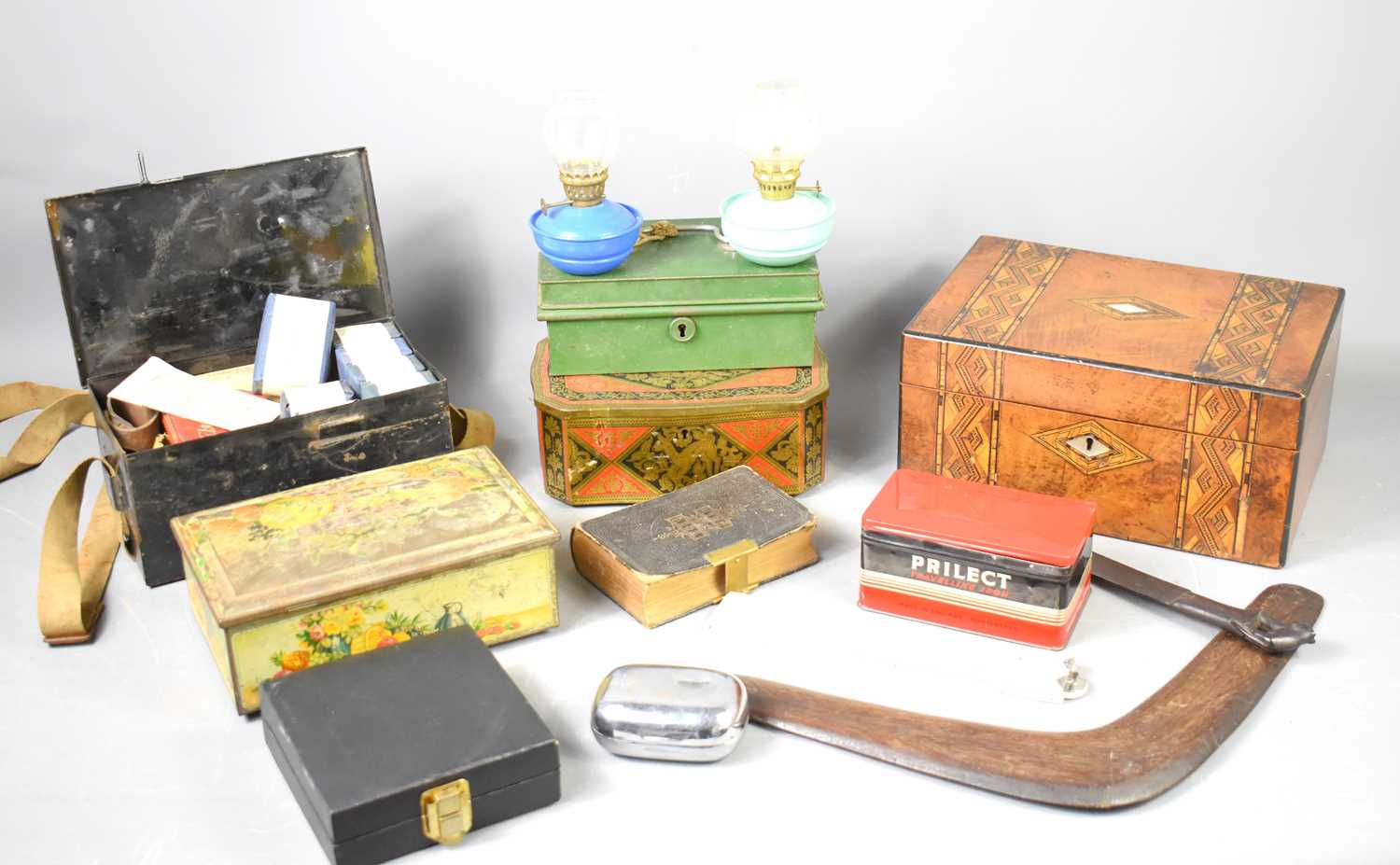 A group of collectable items to include a vintage first aid tin with contents, money box tin, oil