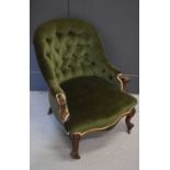 A Victorian nursing chair of small proportions, with scrolling arms, and ornate cabriole legs,