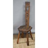 An oak spinning chair with carved back and seat, 96cm total height.